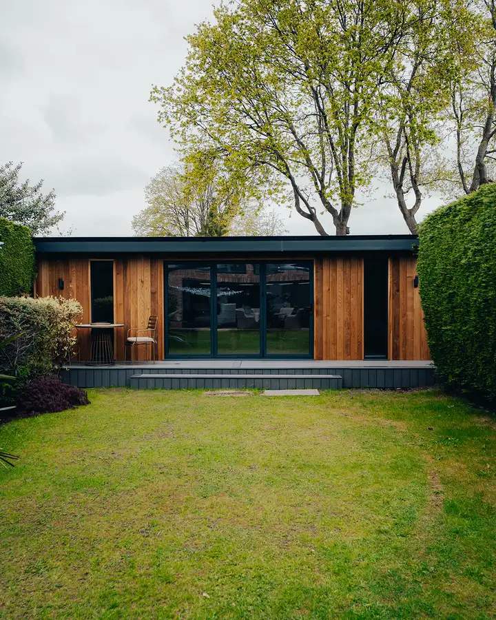 Long anthracite garden room on a lawn