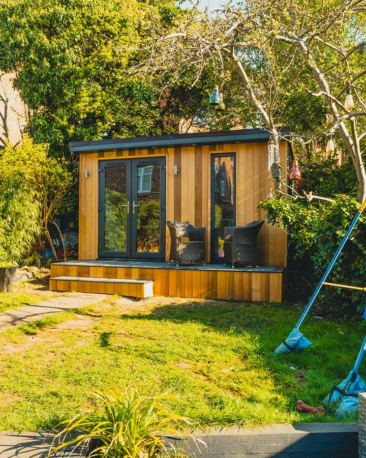 Cedar clad garden room in evening sun