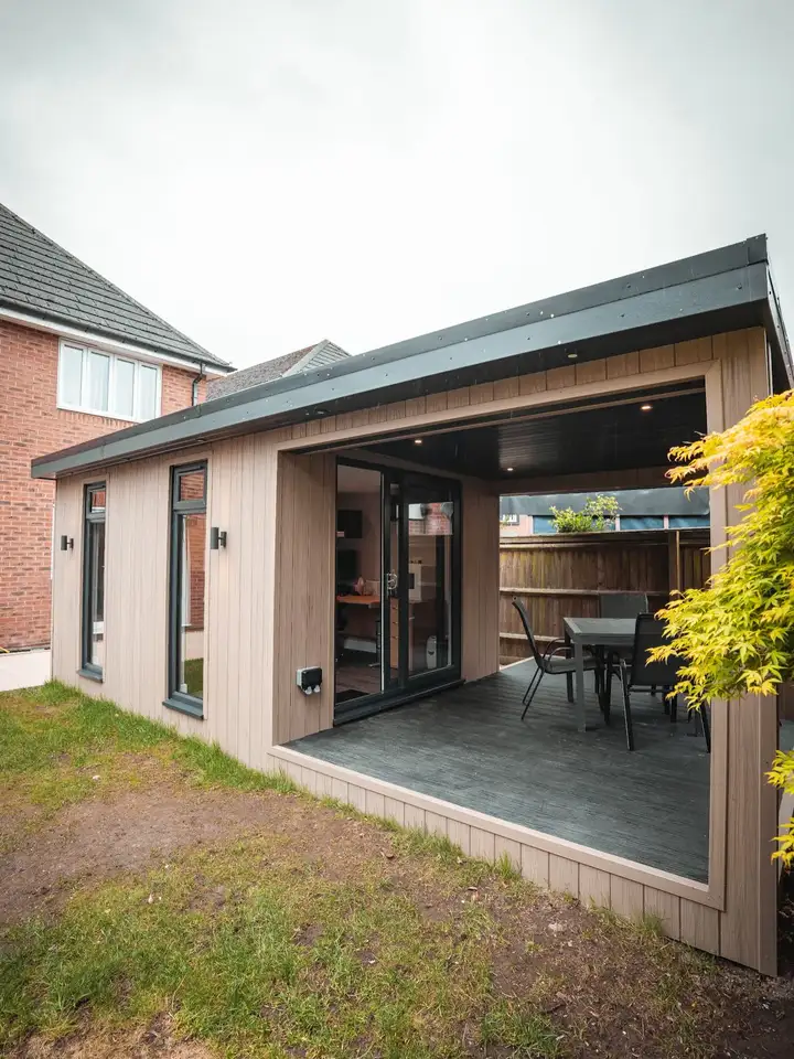 Garden room with open corner doors and outdoor dining area