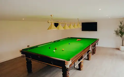 Garden games room with media wall and lounge seating
