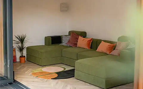 Bright garden studio interior with sofa